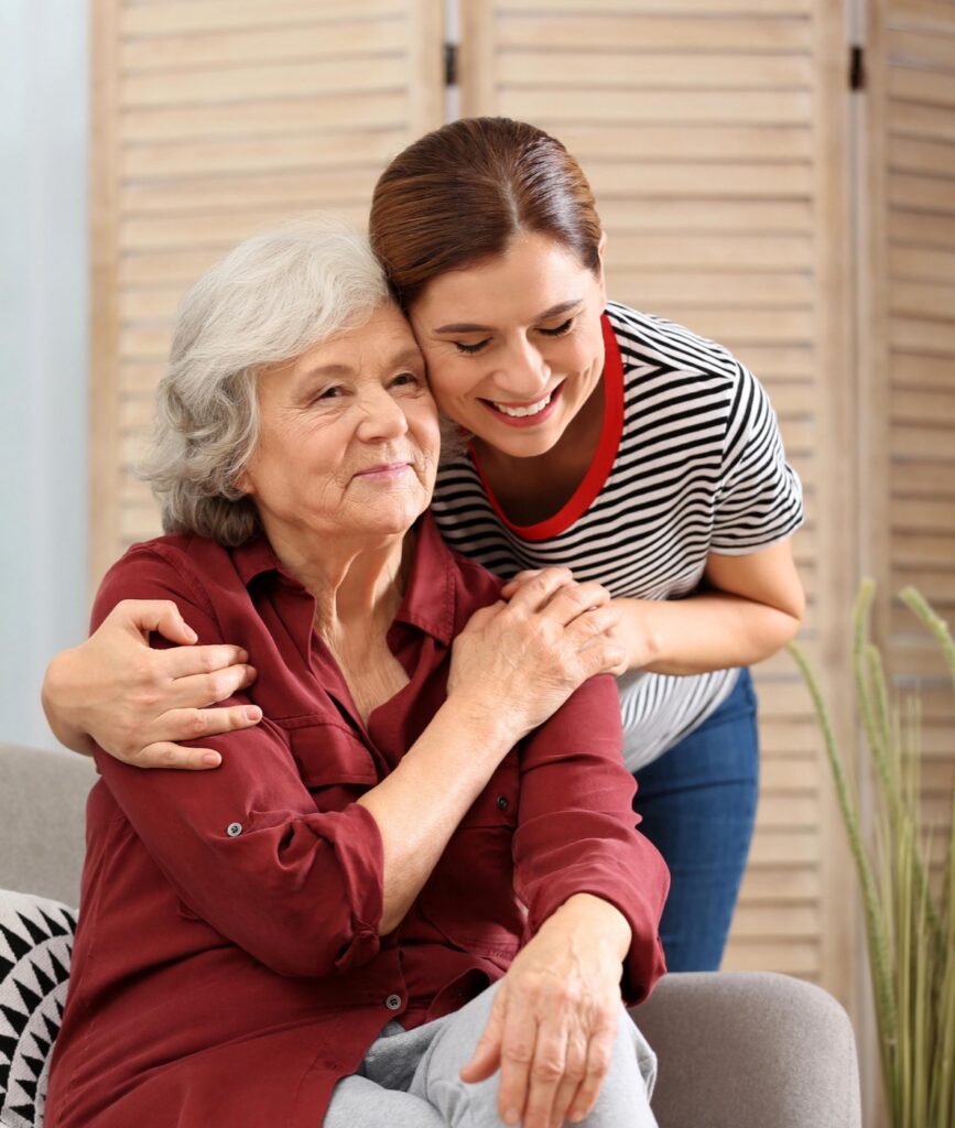 A carer hugging her elderly mother